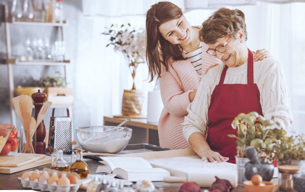 portrait of woman and senior woman cooking