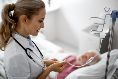 doctor giving infusion therapy to patient