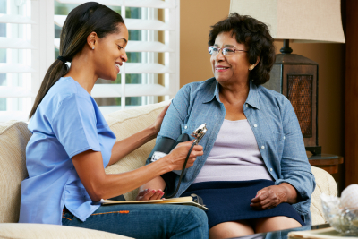 Nurse visiting senior patient at home