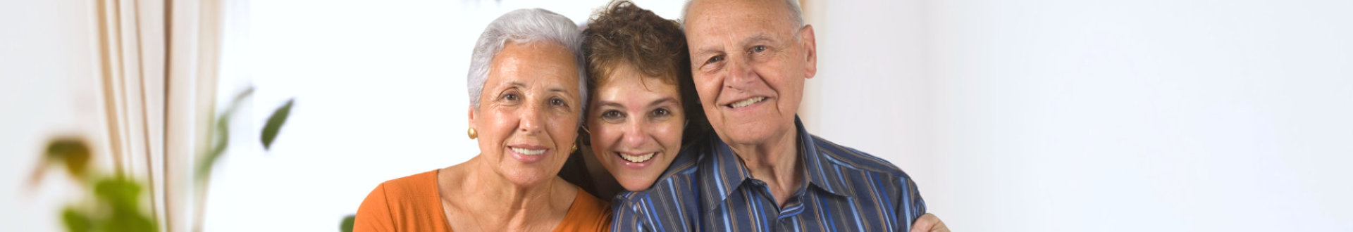 Daughter embracing her senior parents